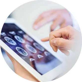Close-up shows tablet with MRI images.