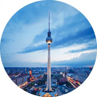 Berlin TV Tower at dusk with a cityscape view.