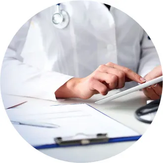 Close-up of a doctor's hands working on a tablet.