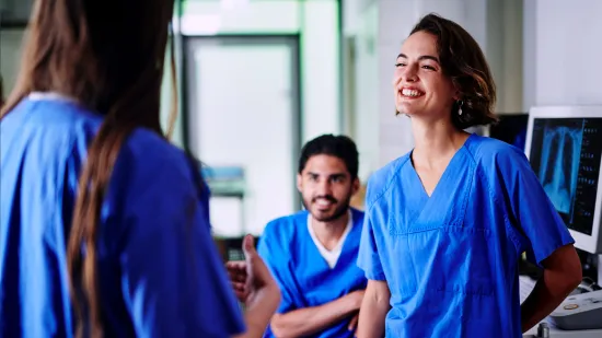 Team of medical professionals engaged in a lively conversation.
